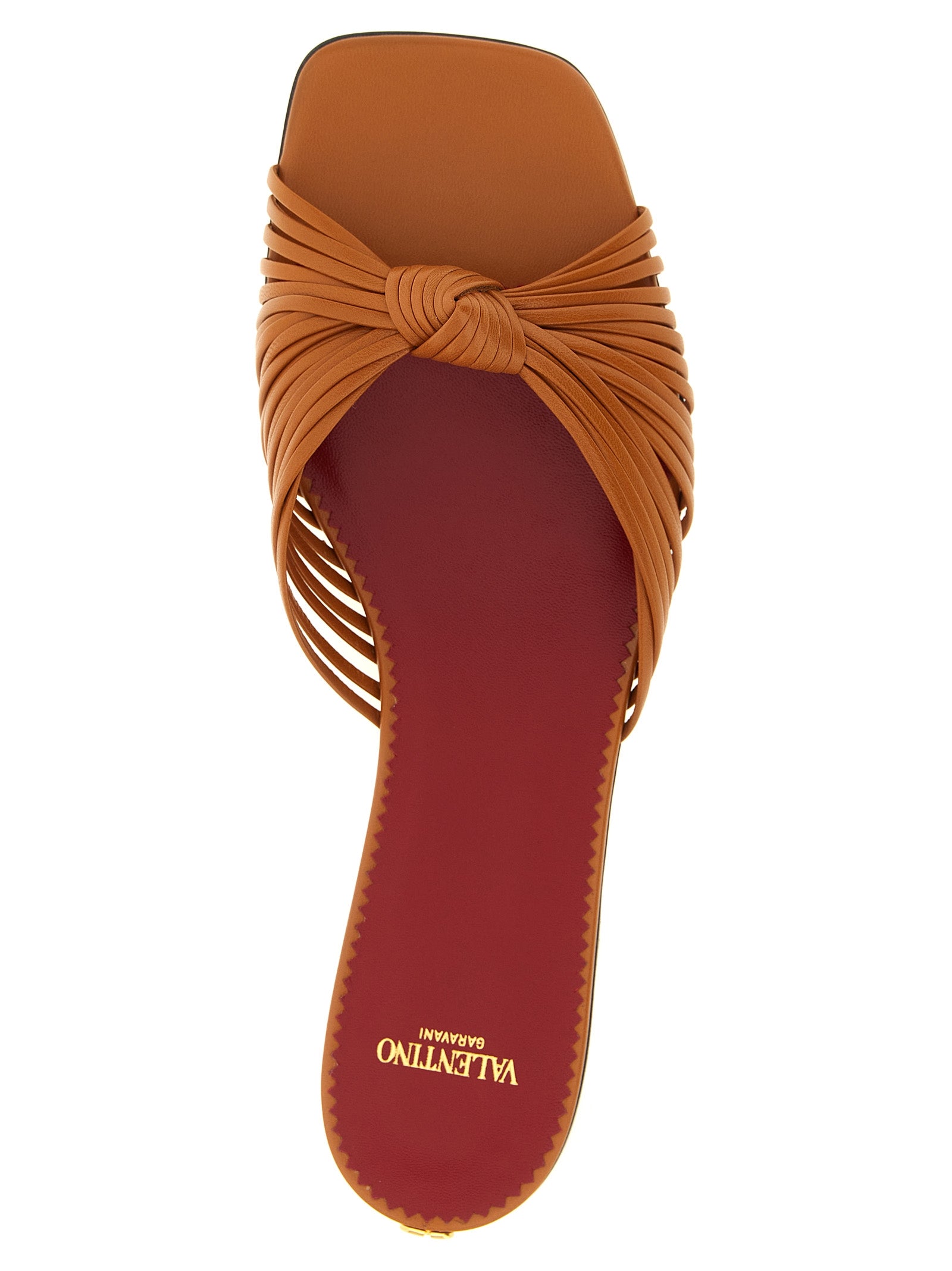 Sliders Sandals Flat Shoes by Valentino Garavani for women in goatskin leather & brass brown & signature showcases a resplendent V Logo Women's Goatskin Leather & Brass Sliders Sandals Flat Shoes aesthetic with a and square toe style.