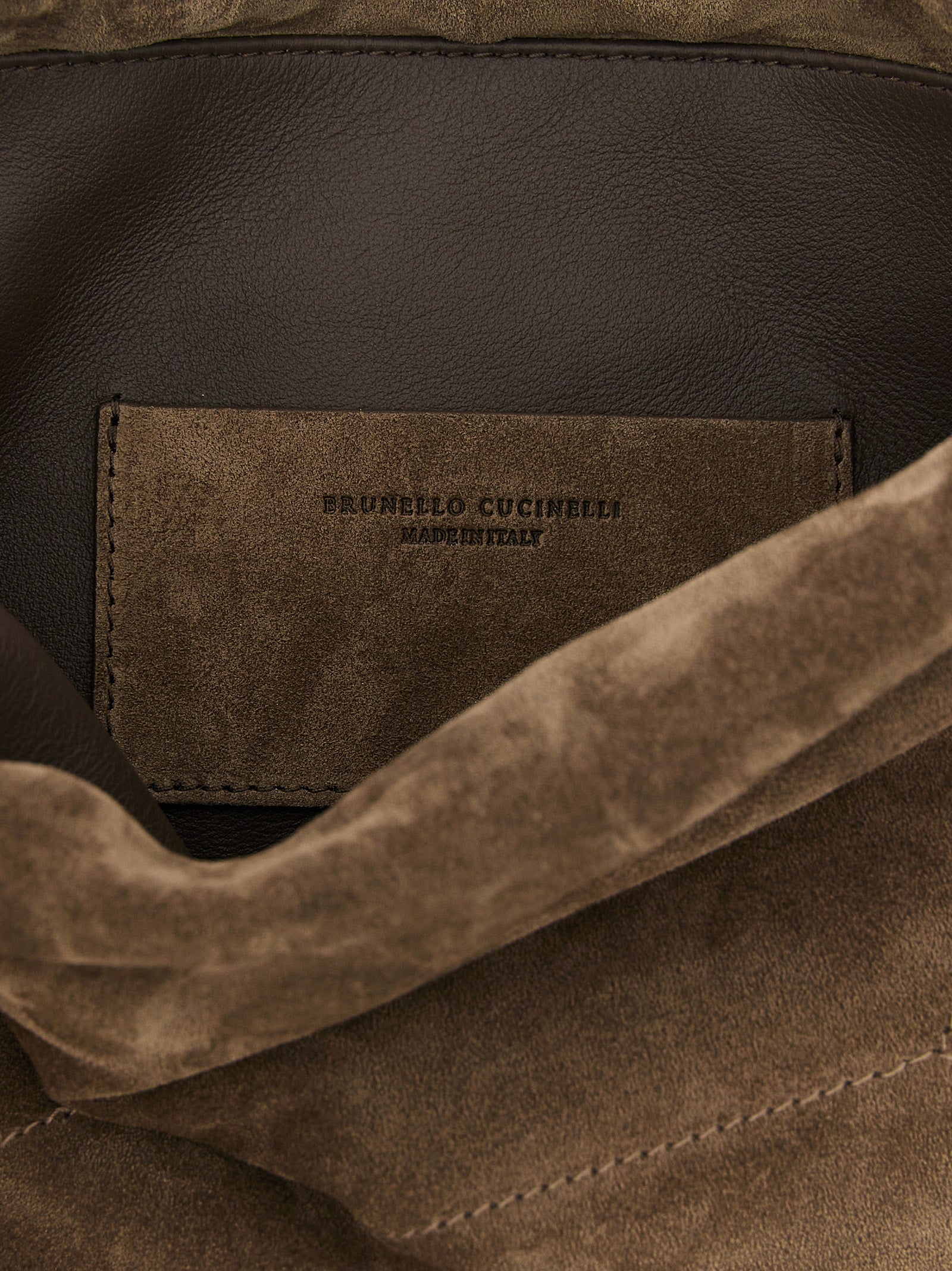 Drawstring Pouch Clutch Handbag by Brunello Cucinelli for women in suede calfskin leather brown & signature features a architectural silhouette, showcasing a secure drawstring, ample , and versatile shoulder-strap for a architectural finish.