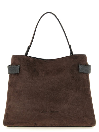 Handbag by Brunello Cucinelli for women in suede calfskin leather brown features a contemporary silhouette, showcasing a secure magnetic, ample , and contemporary shoulder-strap, handle & adjustable-strap for a sophisticated look.