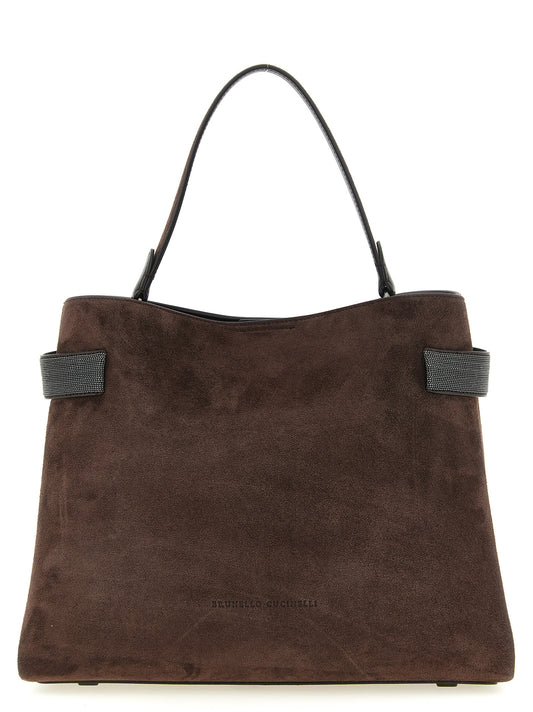 Handbag by Brunello Cucinelli for women in suede calfskin leather brown features a contemporary silhouette, showcasing a secure magnetic, ample , and contemporary shoulder-strap, handle & adjustable-strap for a sophisticated look.