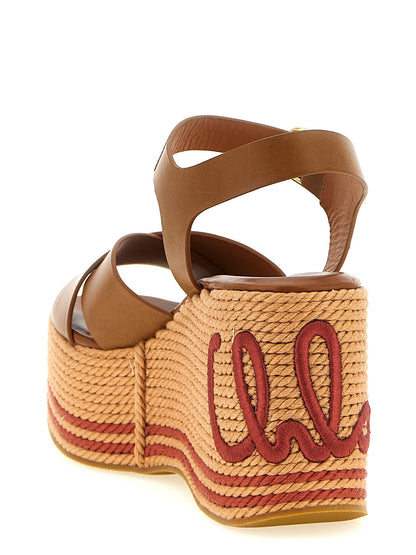 Wedge Ankle Strap Sandals by Chloé for women in calfskin leather & tu brown & signature presents a sculptural silhouette, showcasing the Women's Calfskin Leather & TU Wedge Ankle Strap Sandals design with a sculptural wedge and for a premium look.