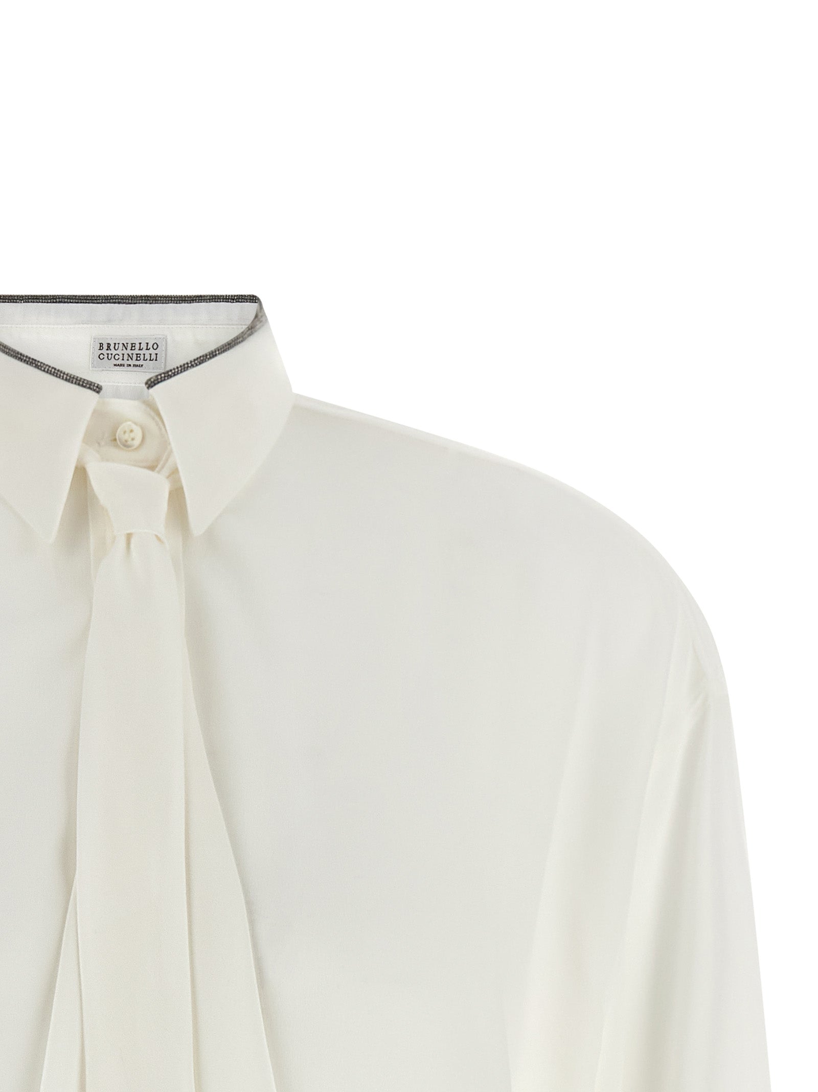 Blouse by Brunello Cucinelli for women in silk white showcases a sharp silhouette, elegantly detailed with a sharp asymmetric neckline and sharp .