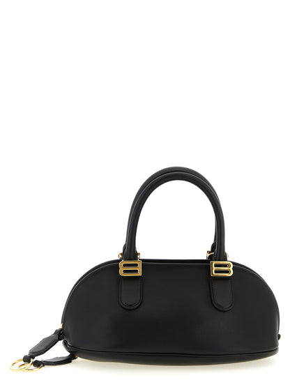 Mini Bowling Handbag by Balenciaga for women in calfskin leather black presents a ornamental silhouette, showcasing a secure zipper, ample , and versatile shoulder-strap & adjustable-strap for a ornamental finish.