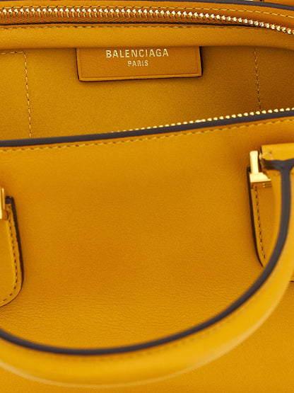 Mini Bowling Handbag by Balenciaga for women in calfskin leather bicolour & yellow presents a ornamental silhouette, showcasing a secure zipper, ample , and versatile shoulder-strap, adjustable-strap & handle for a ornamental finish.