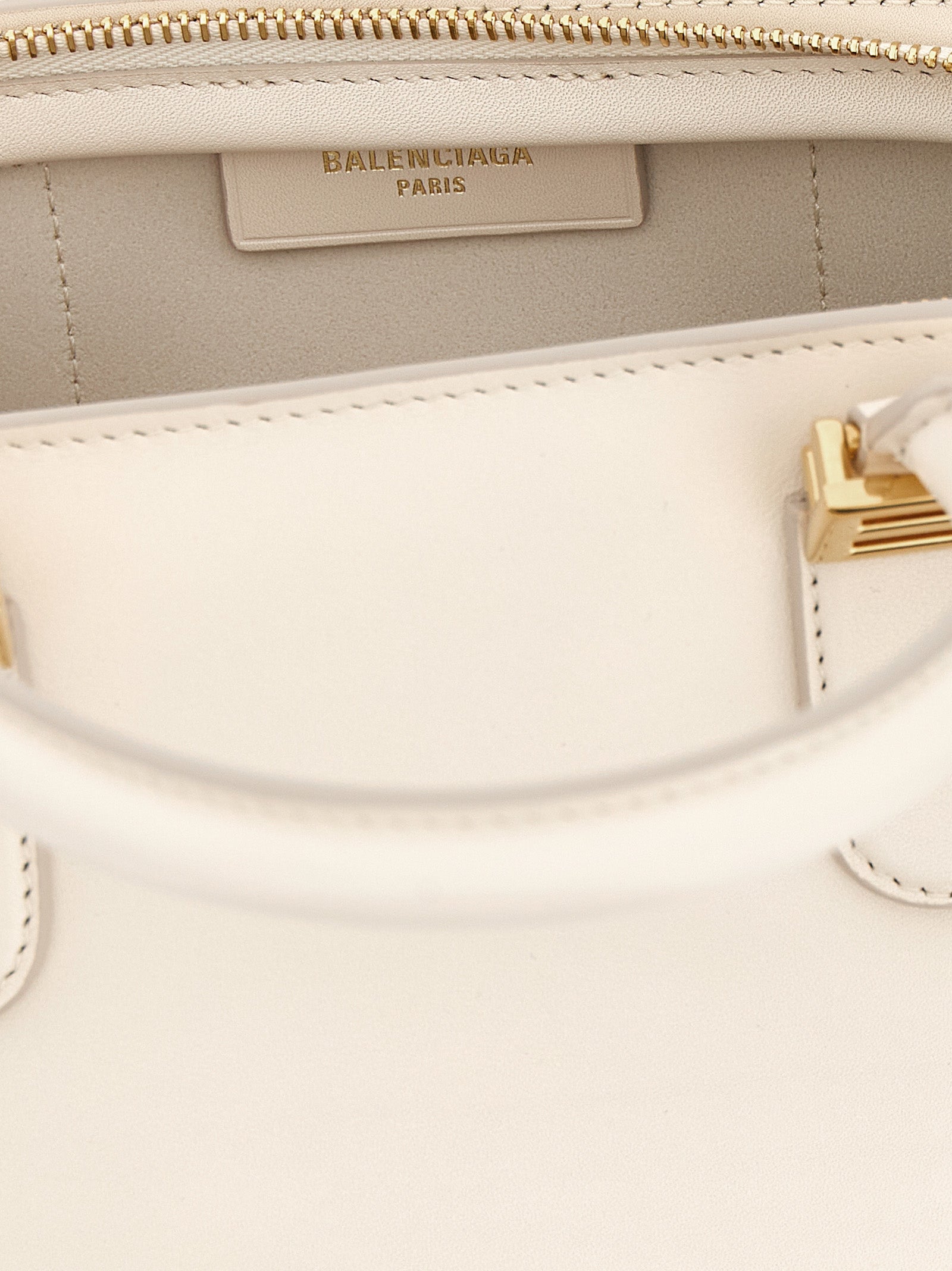 This Mini Handbag by Balenciaga for women in calfskin leather and white presents a sculptural silhouette featuring a secure zipper, ample , and versatile shoulder-strap, adjustable-strap & handle for a sculptural finish.