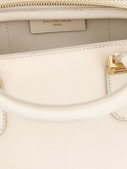 This Mini Handbag by Balenciaga for women in calfskin leather and white presents a sculptural silhouette featuring a secure zipper, ample , and versatile shoulder-strap, adjustable-strap & handle for a sculptural finish.