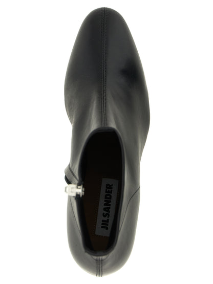 Ankle Boots by Jil Sander for women in calfskin leather black features an effortless chic silhouette from the Women's Calfskin Leather Ankle Boots collection, showcasing a effortless chic and refined almond toe style for an effortless chic look.
