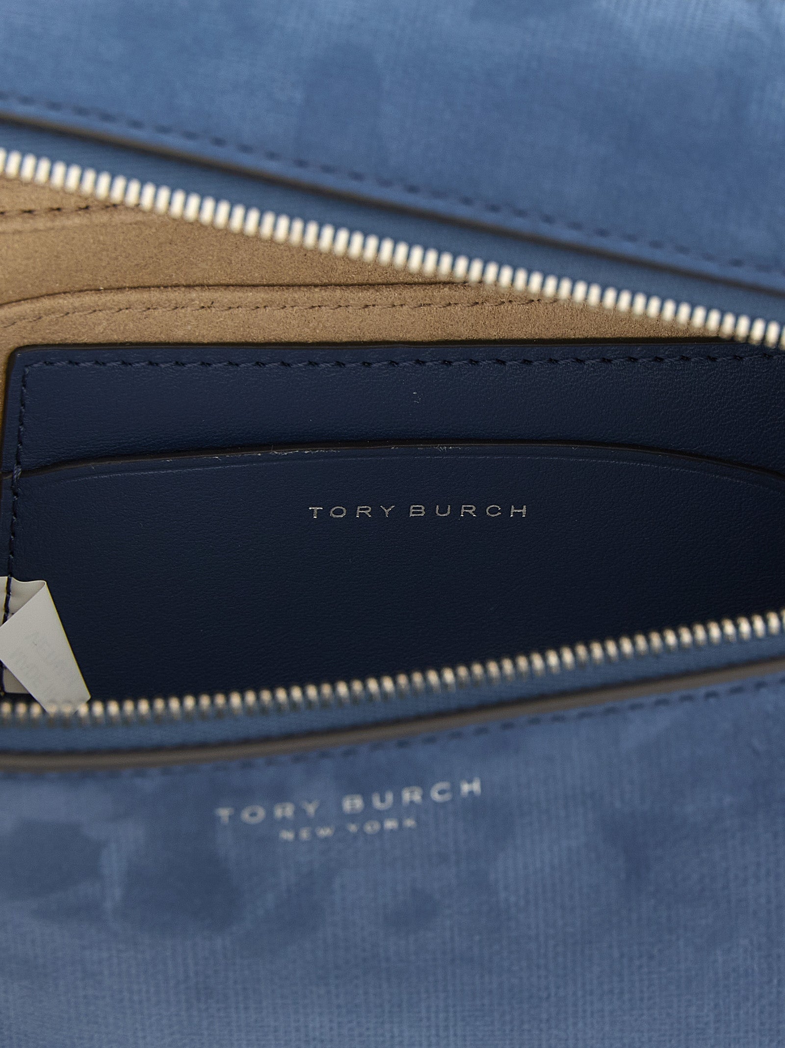 This Handbag by Tory Burch for women in nubuck & suede lamb leather and blue presents a sculptural silhouette featuring a secure , ample , and versatile shoulder-strap, handle & adjustable-strap for a sculptural finish.