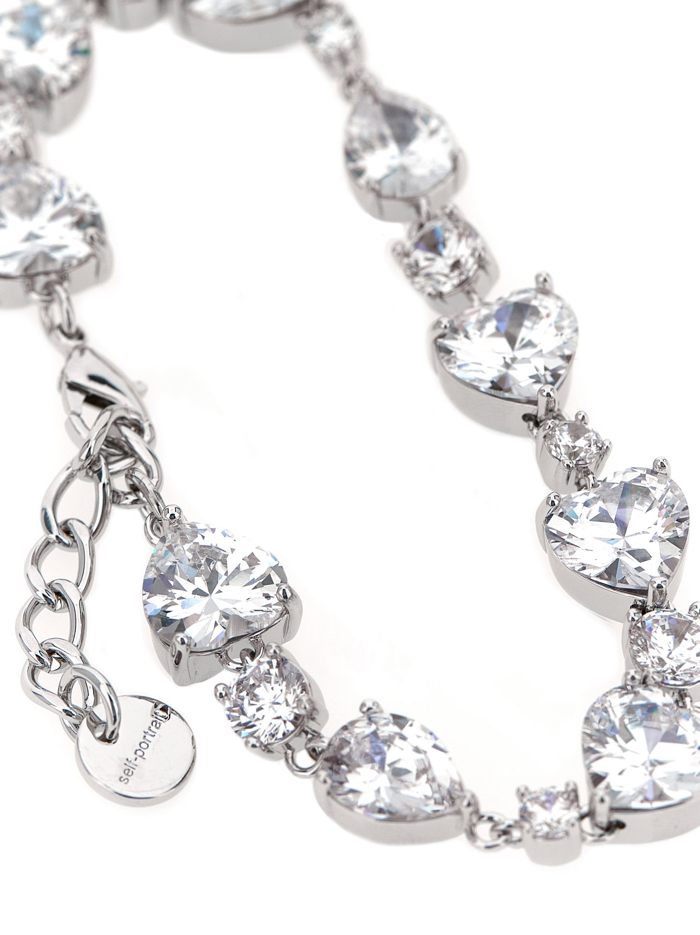 Bracelet by Self-Portrait for women in virgin cashmere wool & leather silver showcases a cosmopolitan silhouette, artfully capturing the essence of the cosmopolitan Heart Women's Silver Brass & Crystal Bracelet with a cosmopolitan .