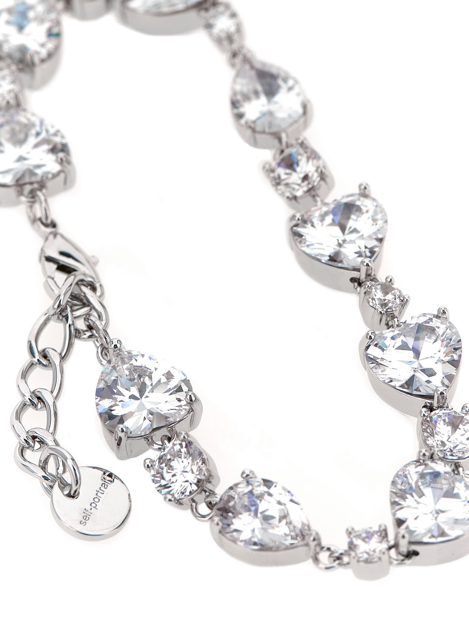 Bracelet by Self-Portrait for women in virgin cashmere wool & leather silver showcases a cosmopolitan silhouette, artfully capturing the essence of the cosmopolitan Heart Women's Silver Brass & Crystal Bracelet with a cosmopolitan .