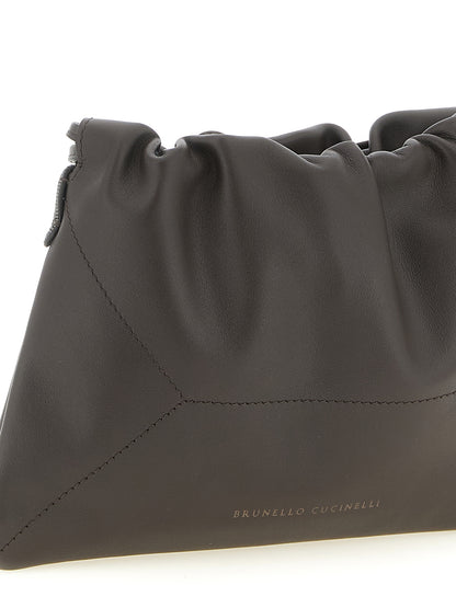 Drawstring Pouch Clutch Handbag by Brunello Cucinelli for women in calfskin leather brown showcases a sculptural silhouette, featuring a secure drawstring, ample , and versatile shoulder-strap for a sculptural aesthetic.