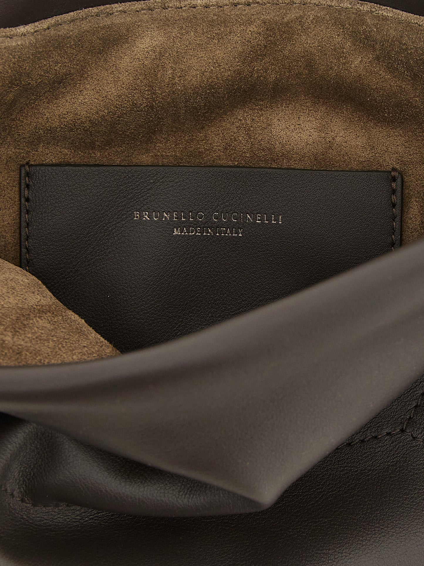 Drawstring Pouch Clutch Handbag by Brunello Cucinelli for women in calfskin leather brown features a sculptural silhouette with a secure drawstring, organized , and versatile shoulder-strap for a sculptural finish.
