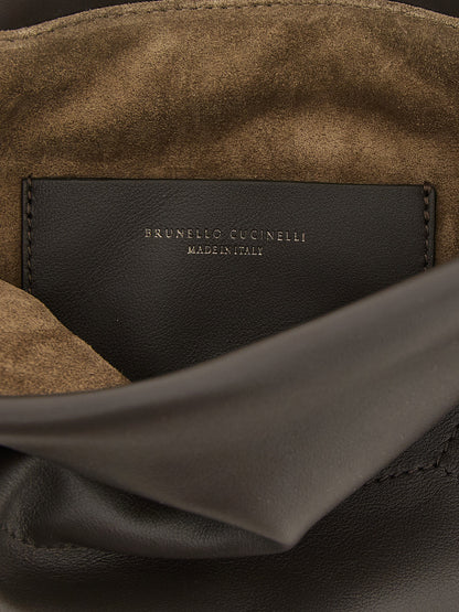 Drawstring Pouch Clutch Handbag by Brunello Cucinelli for women in calfskin leather brown features a sculptural silhouette with a secure drawstring, organized , and versatile shoulder-strap for a sculptural finish.