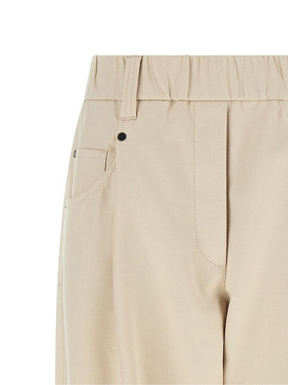 Trousers by Brunello Cucinelli for women in stretch cotton beige presents a smart silhouette, meticulously detailed with a smart tapered-leg & wide, a smart long, and a smart mid rise.