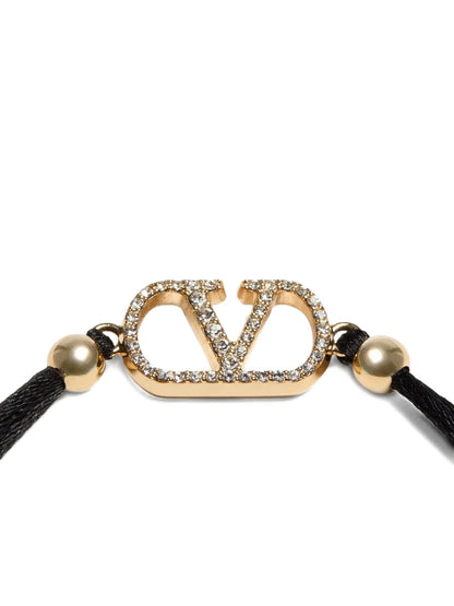 Bracelet by Valentino Garavani for women in nubuck & suede lamb leather black showcases a luminous cord bracelet design, artfully capturing the essence of the luminous V Logo Women's Cord Polyester Leather & Rhinestone Bracelet collection.