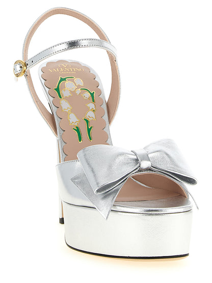 Platform Stiletto Ankle Strap Sandals by Valentino Garavani for women in leather & metal silver, floral & signature features an architectural design from the V Logo Women's Leather & Metal Platform Stiletto Ankle Strap Sandals collection, defined by a architectural stiletto platform and for a architectural finish.