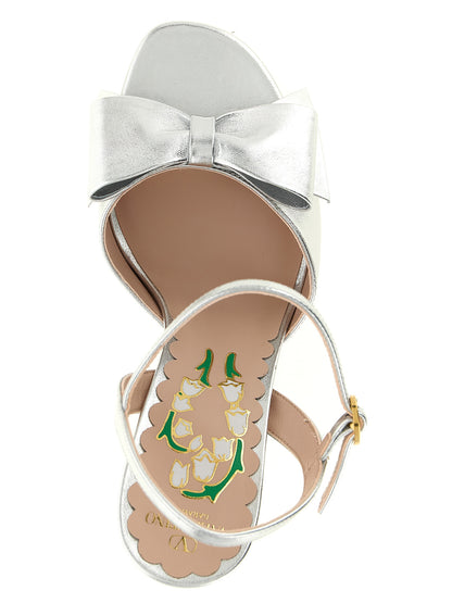 Platform Stiletto Ankle Strap Sandals by Valentino Garavani for women in leather & metal silver, floral & signature features an exquisite silhouette, showcasing the exquisite V Logo Women's Leather & Metal Platform Stiletto Ankle Strap Sandals with a stiletto platform and .