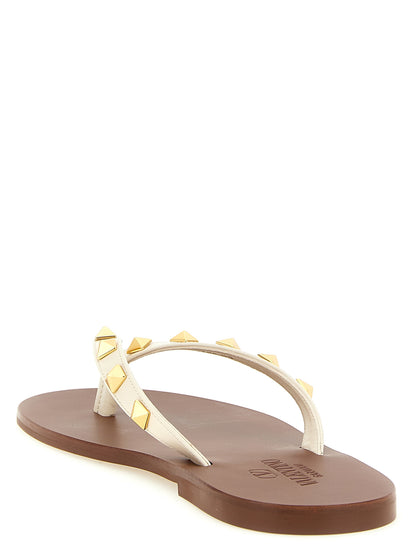 Sliders Sandals Flat Shoes by Valentino Garavani for women in calfskin leather white & signature showcases a dynamic silhouette, artfully capturing Rockstud Women's Calfskin Leather Sliders Sandals Flat Shoes through its distinctive and elegant .