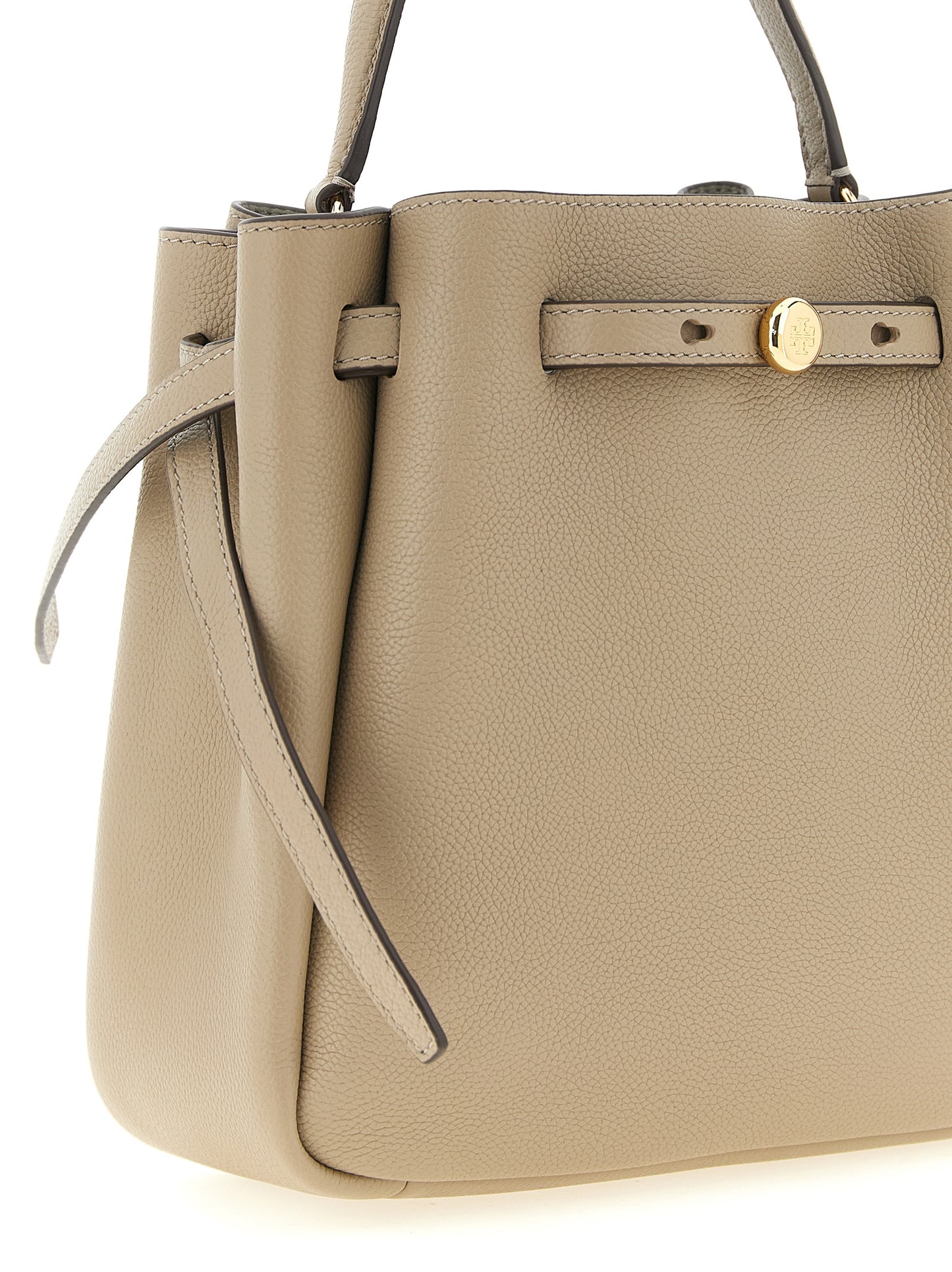 Bucket Handbag by Tory Burch for women in suede leather beige presents a ornamental silhouette, showcasing a secure magnetic, ample , and versatile shoulder-strap, handle, adjustable-strap & belt-strap for a ornamental finish.