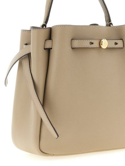 Bucket Handbag by Tory Burch for women in suede leather beige presents a ornamental silhouette, showcasing a secure magnetic, ample , and versatile shoulder-strap, handle, adjustable-strap & belt-strap for a ornamental finish.