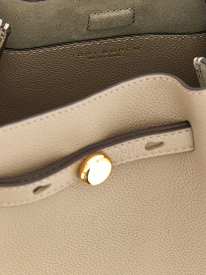 Bucket Handbag by Tory Burch for women in suede leather beige features an refined silhouette, showcasing a secure magnetic, ample , and versatile shoulder-strap, handle, adjustable-strap & belt-strap for a sophisticated refined aesthetic.