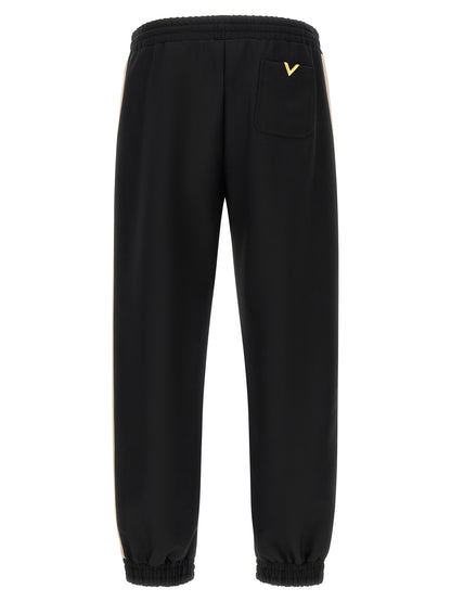 Joggers by Valentino Garavani for men in polyester black & gold features an sophisticated and athletic with a precise long, creating a sophisticated and sophisticated silhouette.