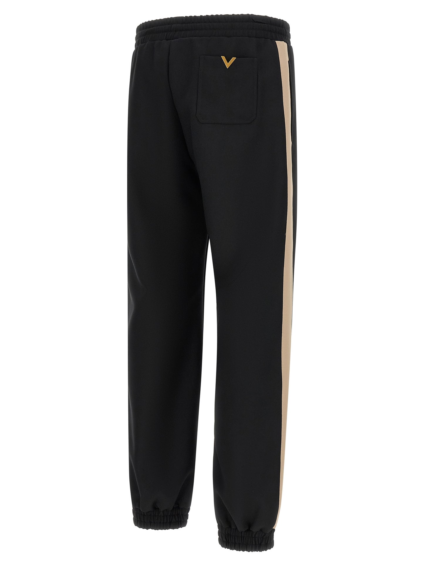 Joggers by Valentino Garavani for men in polyester black & gold features a polished silhouette with a polished athletic, reaching a polished long and finished with a polished .