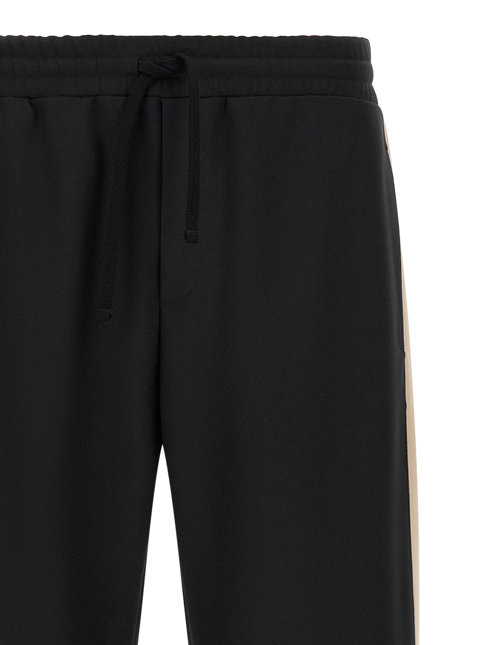 Joggers by Valentino Garavani for men in polyester black & gold presents a refined pantology silhouette, artfully defined by a refined pantology athletic, long, and a sophisticated .