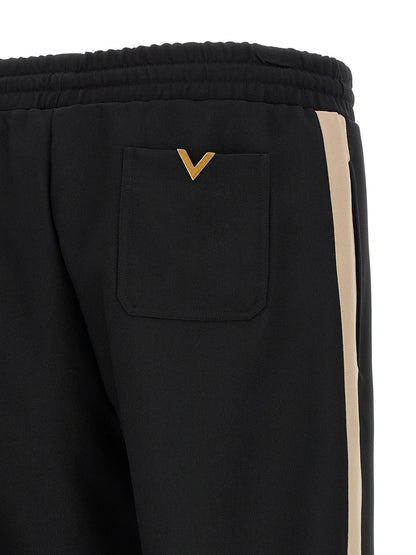 Joggers by Valentino Garavani for men in polyester black & gold features an sophisticated and athletic with a precise long, creating a sophisticated and sophisticated silhouette.