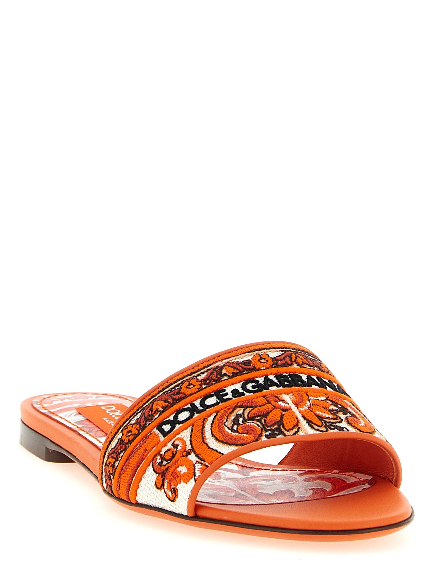 Sliders Flat Shoes by Dolce & Gabbana for women in lamb leather & cotton orange showcases a dynamic silhouette, artfully capturing Maiolica Women's Lamb Leather & Cotton Sliders Flat Shoes through its distinctive and elegant .
