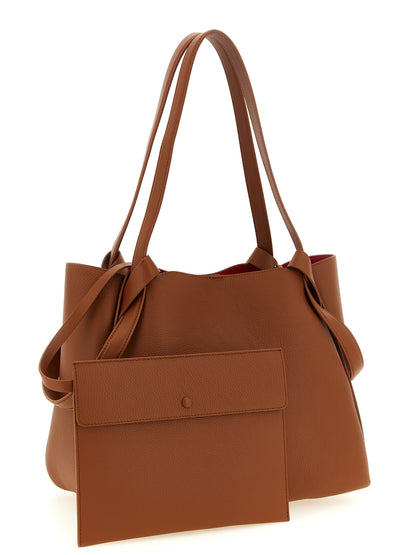 Small Shopper Tote Clutch Bag by Christian Louboutin for women in bos taurus calfskin leather brown features an utilitarian-chic silhouette, showcasing the Bettina Bos Taurus Calfskin Leather Small Shopper Tote Clutch Bag design with a secure snap & hook, ample , and versatile handle.