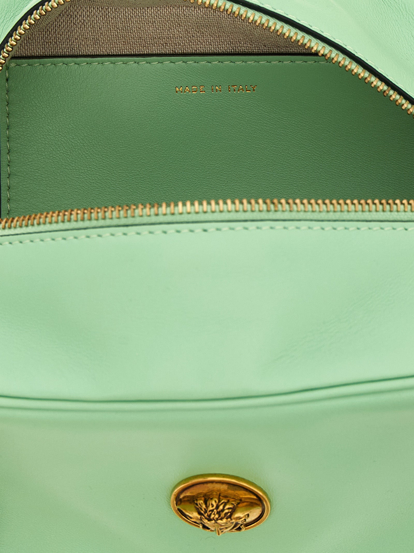 Medium East West Shoulder Bowling Bag by Versace for women in cotton canvas & nappa lambskin leather bicolour, gold & green features a distinguished silhouette, showcasing a secure zipper & buckle and distinguished with versatile shoulder-strap, handle & adjustable-strap for a distinguished finish.