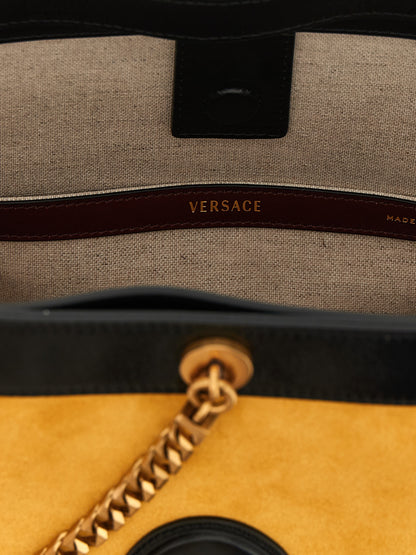 Small Bucket Shoulder Bag by Versace for women in calfskin leather bicolour & yellow features a effortless sophistication silhouette, secured by a magnetic with ample and versatile handle for a effortless sophistication finish.
