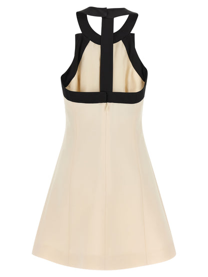 Dress by Valentino Garavani for women in silk crepe & virgin wool bicolour, black & white features an sultry silhouette defined by a and , falling to an sultry short mini for a sultry look.