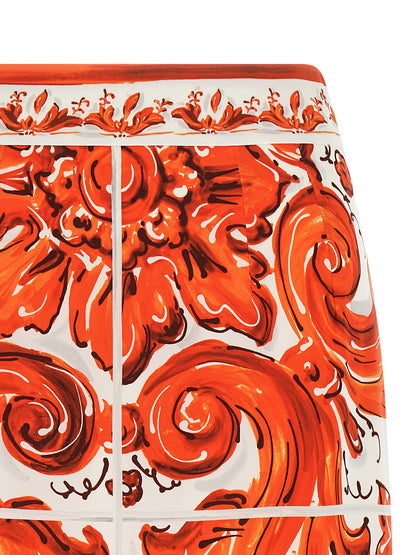 Skirt by Dolce & Gabbana for women in silk orange & print features a captivating silhouette, showcasing the captivating Essence Maiolica Women's High Rise Silk Skirt design with a sophisticated midi for a captivating look.