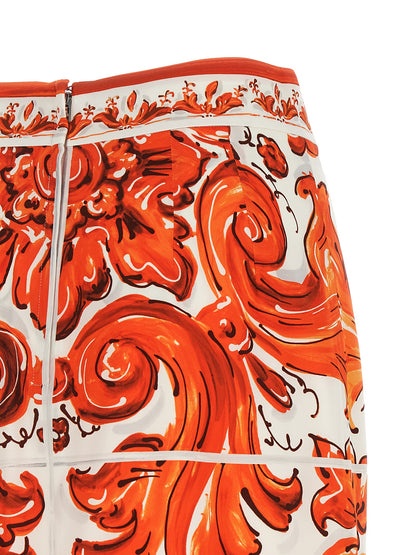 Skirt by Dolce & Gabbana for women in silk orange & print features a sublime silhouette, showcasing the sublime design of the Essence Maiolica Women's High Rise Silk Skirt in a sophisticated midi.