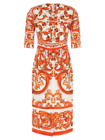 Dress by Dolce & Gabbana for women in silk orange & print features an eye catching silhouette with a sophisticated crew split neckline, elegant , and a refined midi for a eye catching aesthetic.