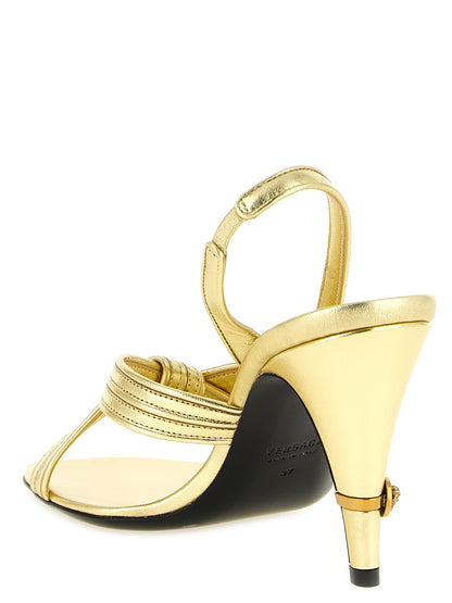 Stiletto Sandals by Versace for women in lamb leather gold presents a sculptural silhouette, showcasing the Medusa Women's Lamb Leather Stiletto Sandals design with a sculptural stiletto and for a premium look.