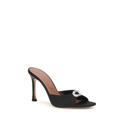 Stiletto Mules Sandals by Amina Muaddi for women in silk satin & crystal black features an exquisite silhouette, showcasing the exquisite Camelia Women's Silk Satin & Crystal Stiletto Mules Sandals with a stiletto and open toe style.