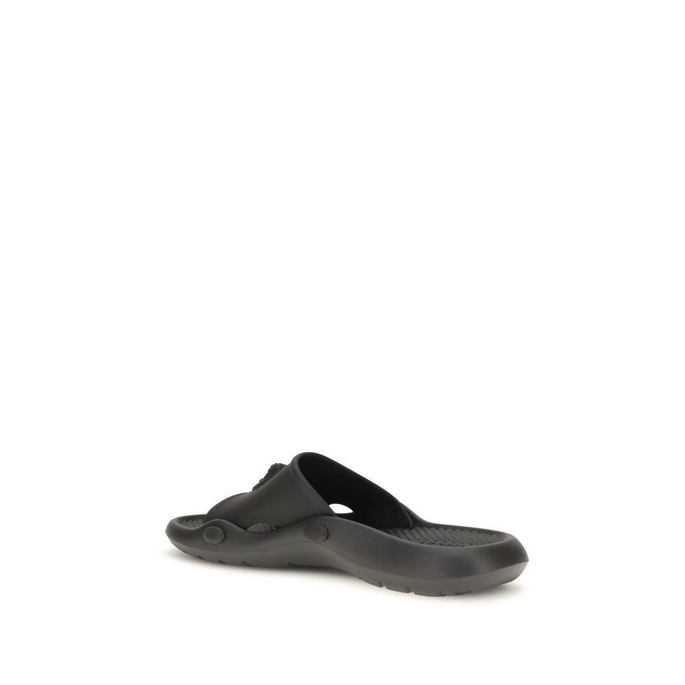 Slider Sandals by Versace for men in rubber black features an exquisite silhouette, showcasing the exquisite Medusa Men's Rubber Slider Sandals with a and .