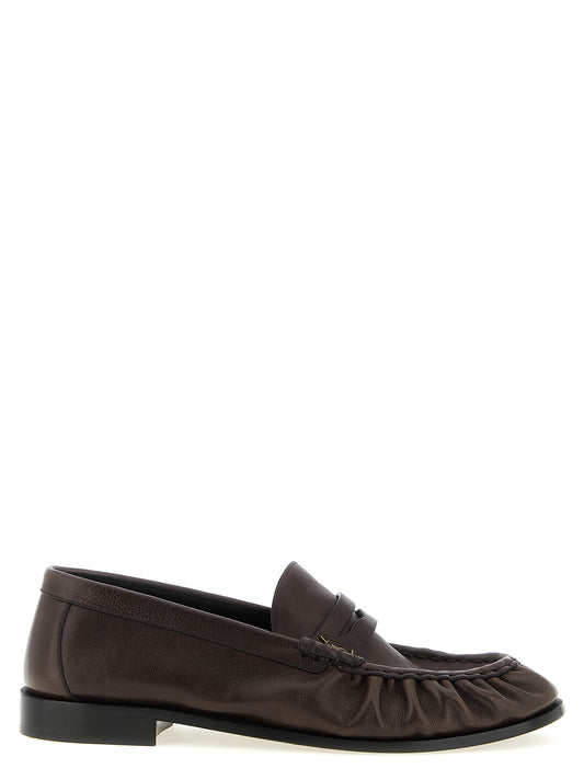 Loafer Slip-On Shoes by Saint Laurent for men in calfskin leather brown & signature features an effortless chic silhouette, showcasing the Cassandre Men's Calfskin Leather Loafer Slip-On Shoes design with an effortless chic and a moc toe style for a effortless chic look.