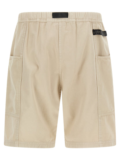 Bermuda Shorts by Gramicci for men in canvas cotton twill beige & signature features an nuanced silhouette, showcasing a nuanced with a short cut and for a sophisticated, premium finish.