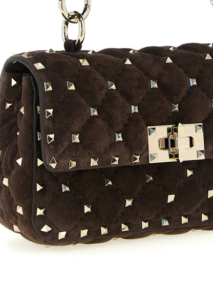 Small Shoulder Flap Bag by Valentino Garavani for women in suede calfskin leather brown features a distinguished silhouette, showcasing a secure flap and distinguished with versatile shoulder-strap, detachable-strap & handle for a distinguished finish.