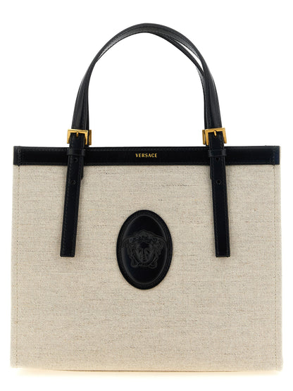 Medium Shopper Tote Bag by Versace for women in suede calfskin leather & cotton canvas beige & print showcases a urban-chic Medusa Riviere Suede Calfskin Leather & Cotton Canvas Medium Shopper Tote Bag design, featuring a secure , ample built-in-compartments, and versatile shoulder-strap, handle & adjustable-strap for a urban-chic finish.