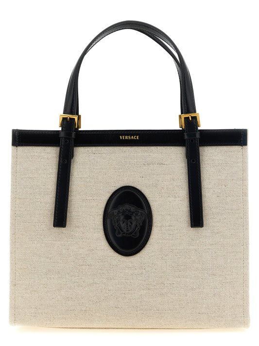 Medium Shopper Tote Bag by Versace for women in suede calfskin leather & cotton canvas beige & print showcases a urban-chic Medusa Riviere Suede Calfskin Leather & Cotton Canvas Medium Shopper Tote Bag design, featuring a secure , ample built-in-compartments, and versatile shoulder-strap, handle & adjustable-strap for a urban-chic finish.