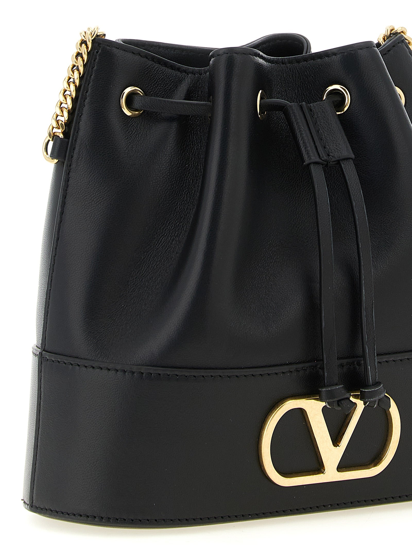 Crossbody Bucket Handbag by Valentino Garavani for women in lamb leather black & signature features an versatile silhouette, showcasing a secure drawstring and versatile with versatile crossbody-strap & shoulder-strap for a versatile finish.