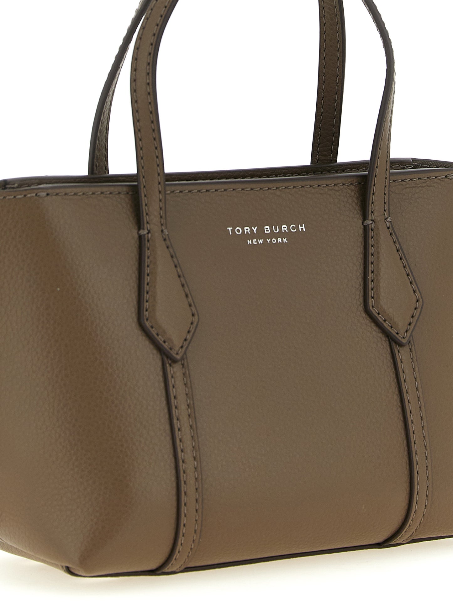 This Mini Shopper Tote Bag by Tory Burch for women in leather & cotton brown features an on trend Perry Leather & Cotton Mini Shopper Tote Bag design with a secure , ample , and on trend shoulder-strap, adjustable-strap & handle.