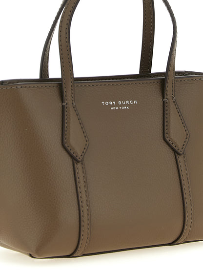 This Mini Shopper Tote Bag by Tory Burch for women in leather & cotton brown features an on trend Perry Leather & Cotton Mini Shopper Tote Bag design with a secure , ample , and on trend shoulder-strap, adjustable-strap & handle.
