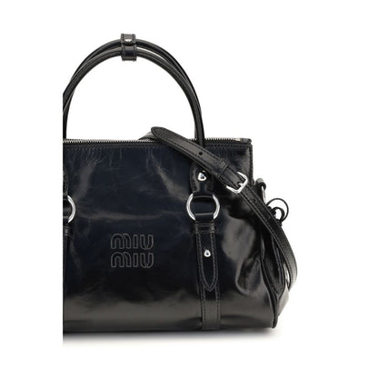 Crossbody Handbag by Miu Miu for women in bos taurus calf leather & plexiglass black features a signature silhouette, showcasing a secure zipper and signature with versatile crossbody-strap, shoulder-strap, adjustable-strap & handle for a sophisticated look.