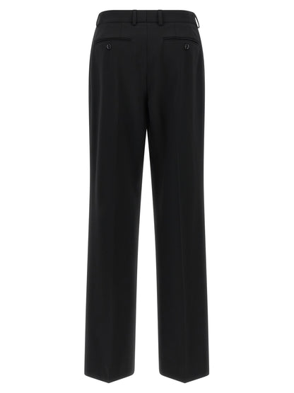 Trousers by Dolce & Gabbana for women in virgin wool black presents a smart silhouette, meticulously detailed with a smart flared, a smart long, and a smart mid rise.